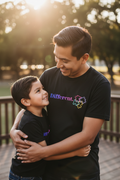 Latino father and son wearing matching black Different. autism awareness graphic t-shirts